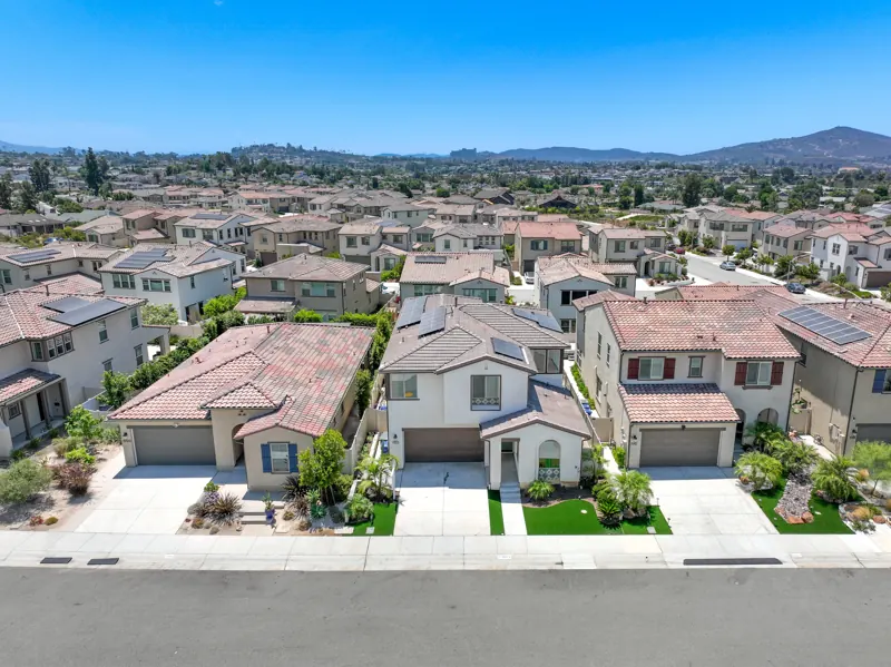 Aerial view of a neighbourhood of stucco tile-roofed homes in Escondido, California